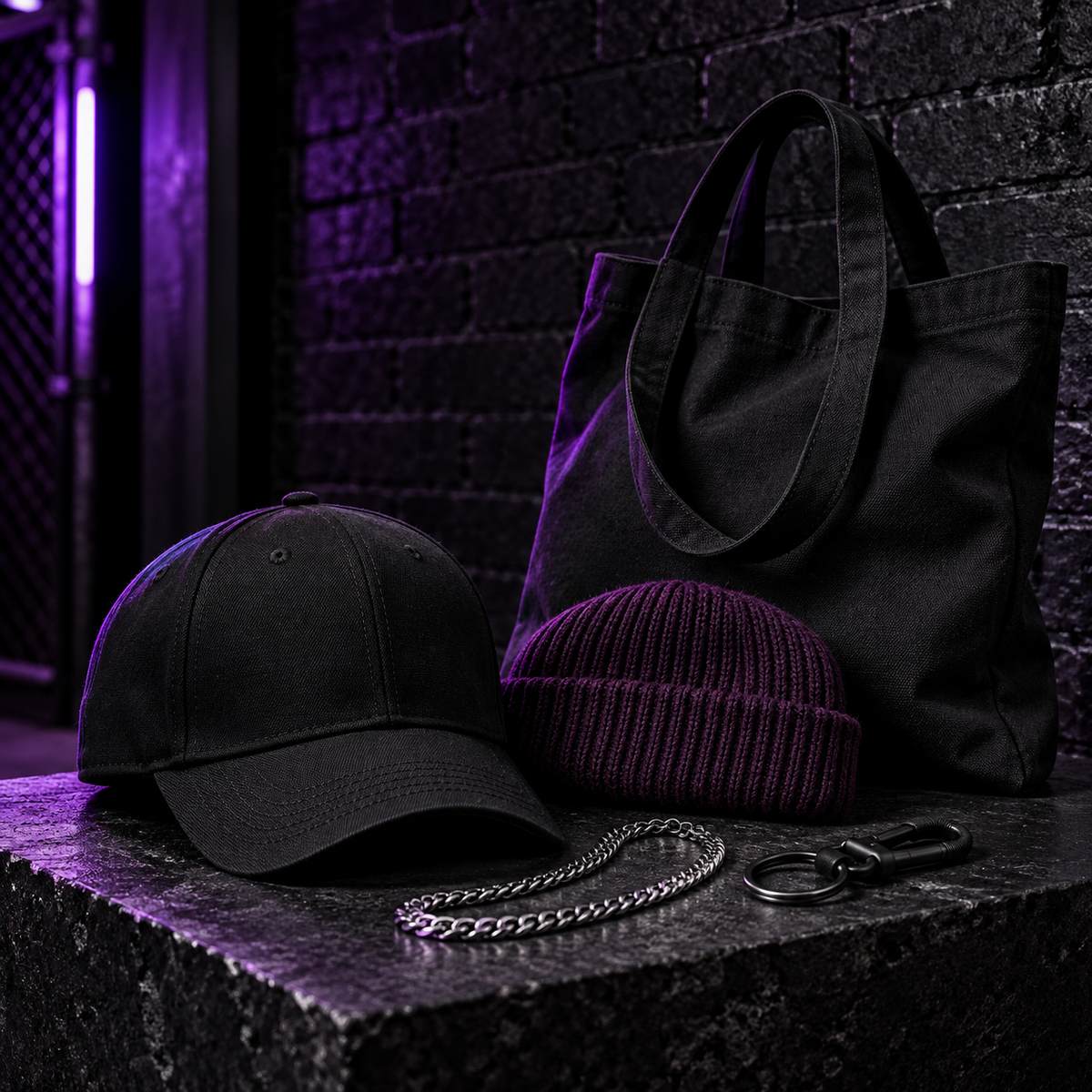 Black cap, purple beanie, canvas tote and accessories on a dark display