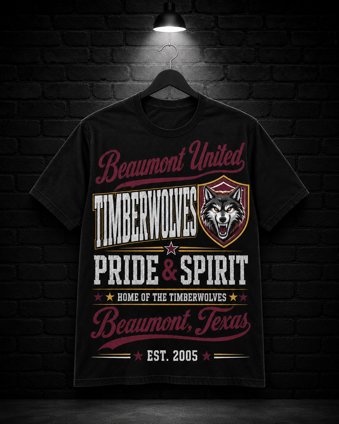 Beaumont United Timberwolves Pride & Spirit Tee on the 25/8 matte black brick studio background with black hanger and overhead spotlight