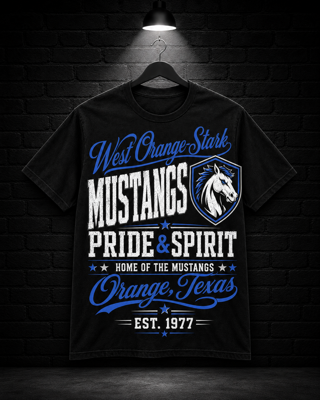 West Orange-Stark Mustangs Pride & Spirit Tee on the 25/8 matte black brick studio background with black hanger and overhead spotlight