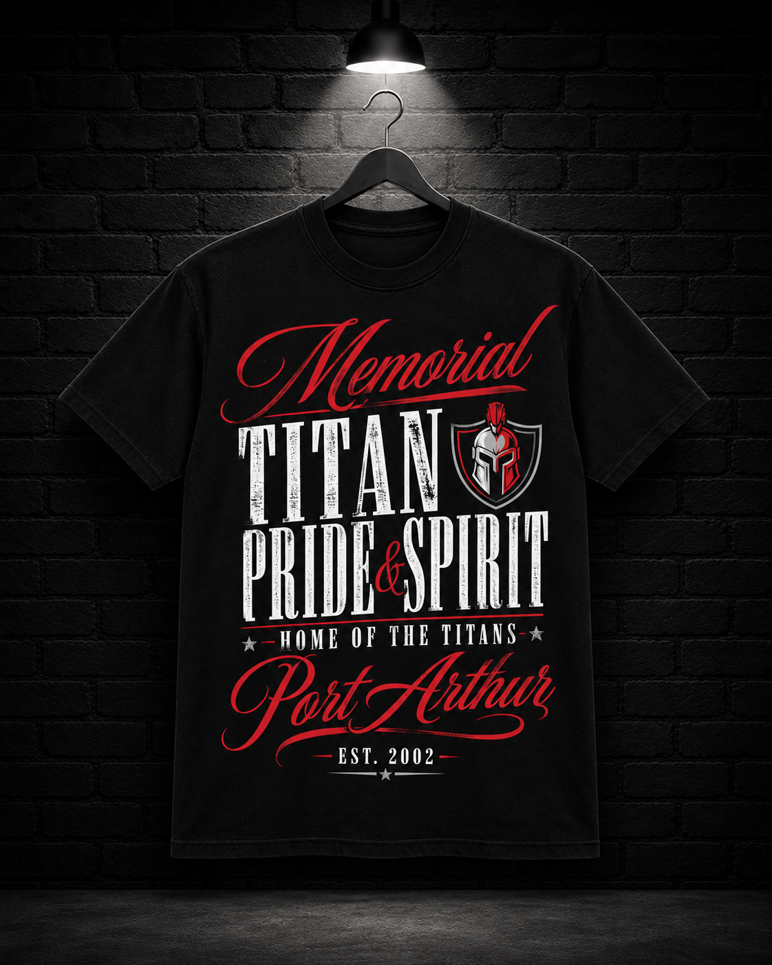 Memorial Titans Pride & Spirit Crest Tee on the 25/8 matte black brick studio background with black hanger and overhead spotlight