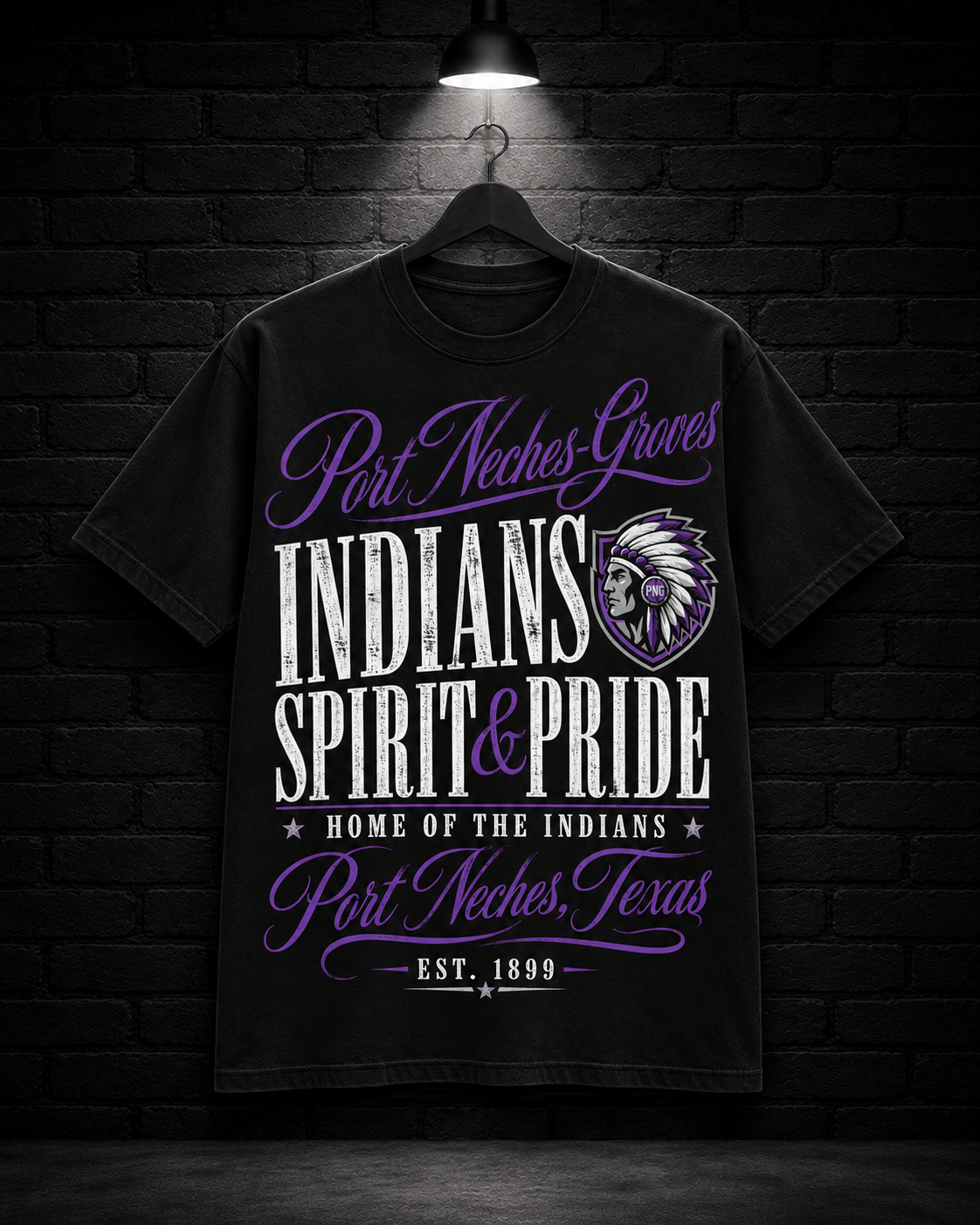 Port Neches-Groves Spirit & Pride Tee on the 25/8 matte black brick studio background with black hanger and overhead spotlight